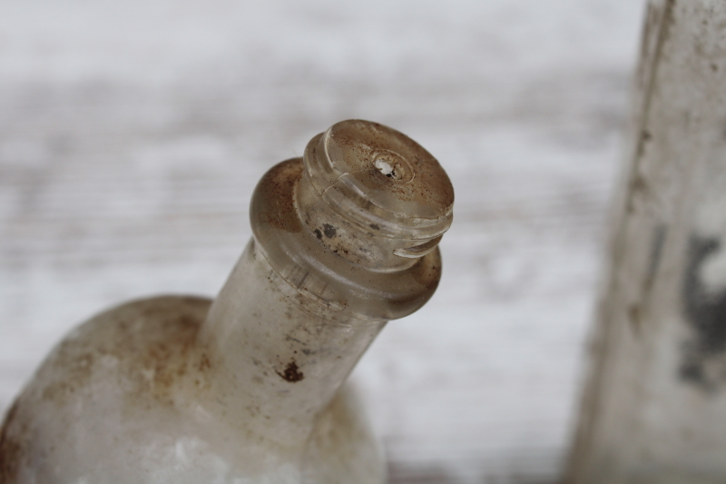 photo of vintage embossed glass medicine bottles, spooky old dug bottles for creepy haunted Halloween #5