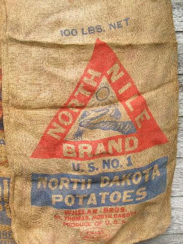 photo of vintage farm primitive burlap potato bags w/ bright advertising graphics #4