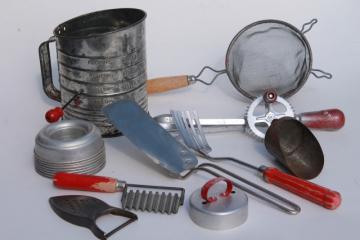 catalog photo of vintage farmhouse kitchenware lot, red handled kitchen tools, utensils, jello molds etc.