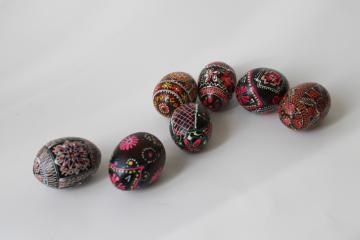 photo of vintage folk art, hand painted wooden Easter eggs, dark brown & black w/ bright colors