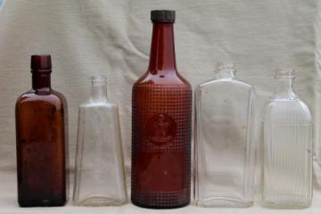 catalog photo of vintage glass bottles, patent medicine or distillery bottles, old whiskey bottle lot