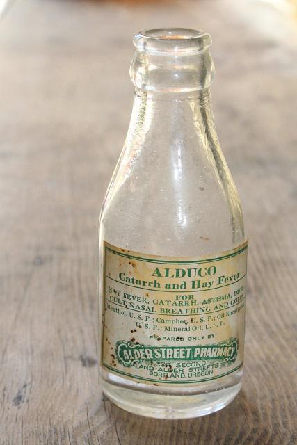 photo of vintage glass medicine bottle w/ old paper label Alder St pharmacy Portland Oregon #1