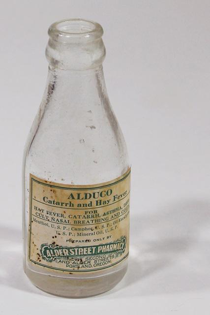 photo of vintage glass medicine bottle w/ old paper label Alder St pharmacy Portland Oregon #2