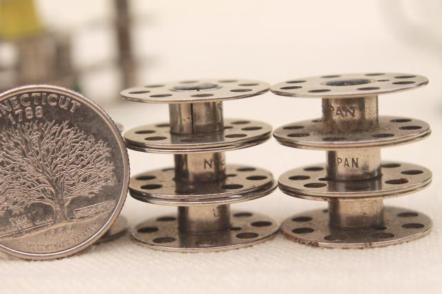 photo of vintage glass store counter candy jar full of old metal thread bobbins #2