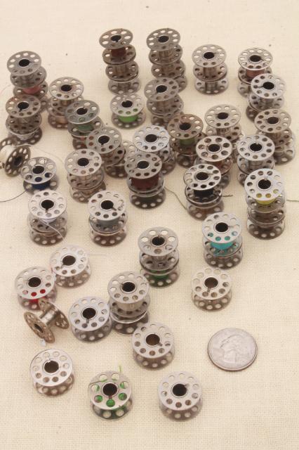 photo of vintage glass store counter candy jar full of old metal thread bobbins #7