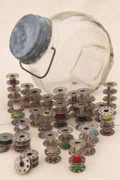 catalog photo of vintage glass store counter candy jar full of old metal thread bobbins