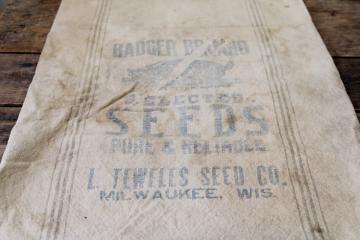 catalog photo of vintage grain sack, primitive cotton fabric w/ grey stripe, faded advertising Badger brand