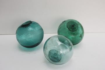 catalog photo of vintage hand blown glass fishing net floats in shades of sea glass green & aqua