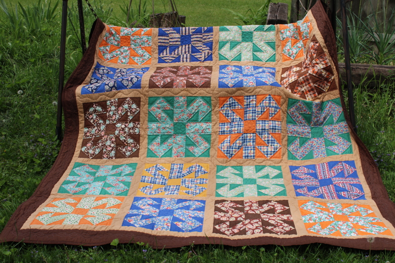 photo of vintage hand stitched handmade patchwork quilt, all cotton fabrics brown w/ mid century prints, retro colors #1