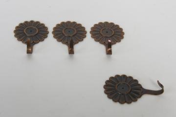 catalog photo of vintage hooks or wall hangers, small metal flowers to mount with push pins or tacks