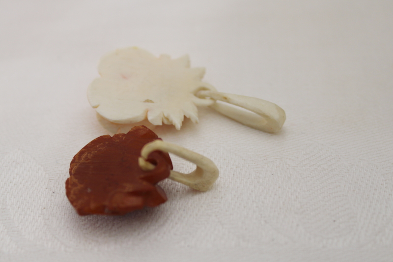 photo of vintage jewelry, carved bone rose pendants, one white, one brown #2