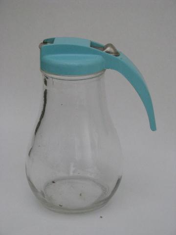 photo of vintage kitchenware lot, collection of kitchen glass syrup pitchers #2