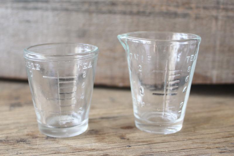 photo of vintage medicine glasses, shot glass size w/ embossed measures marked doses #1