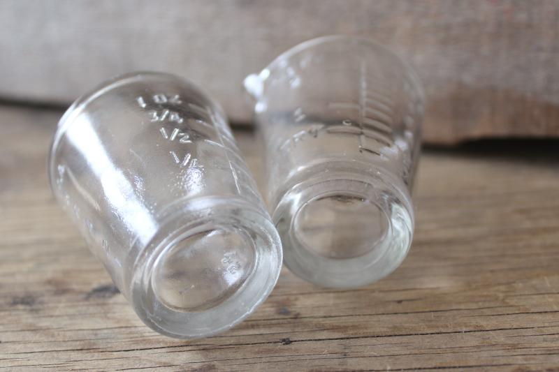 photo of vintage medicine glasses, shot glass size w/ embossed measures marked doses #2