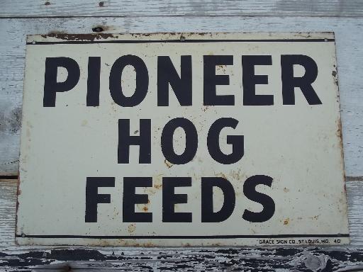 photo of vintage metal sign Pioneer Hog Feed, old farm feed mill advertising #1