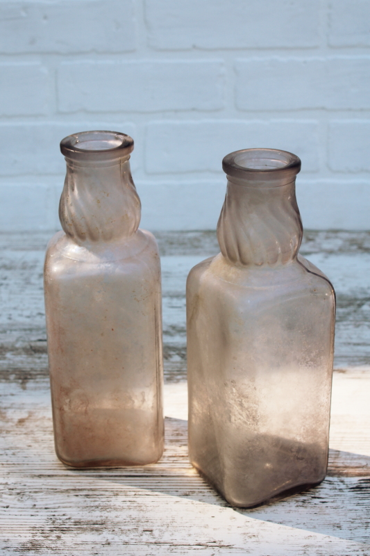 photo of vintage milk bottles, large old dug bottles w/ wear and patina, sun purple lavender glass w/ iridescence #1