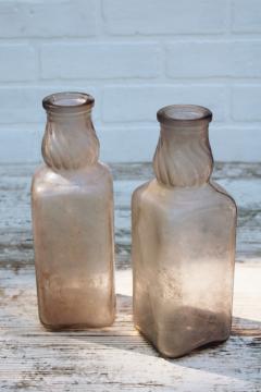 catalog photo of vintage milk bottles, large old dug bottles w/ wear and patina, sun purple lavender glass w/ iridescence