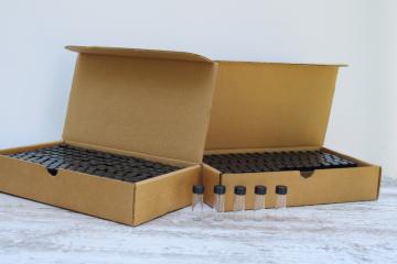 catalog photo of vintage new old stock cases of one dram vials, tiny glass bottles w/ screw on lids 