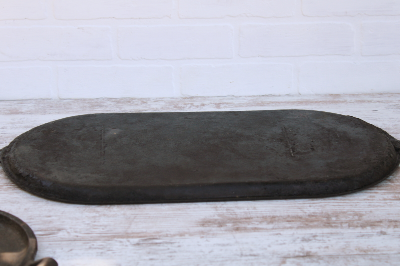 photo of vintage or antique cast iron griddles number 8-9, long oval pans gate mark bottoms #3