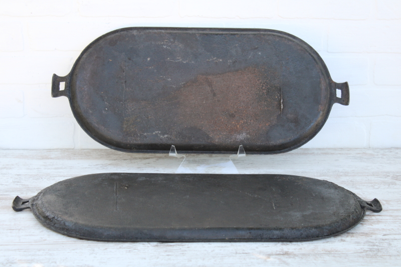 photo of vintage or antique cast iron griddles number 8-9, long oval pans gate mark bottoms #5