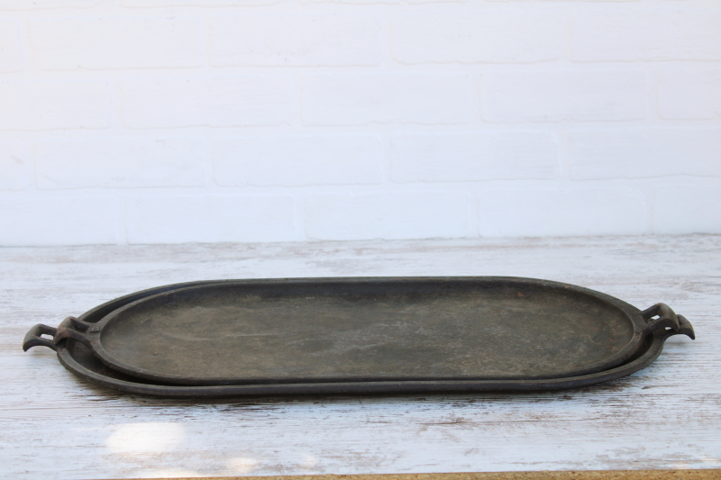 photo of vintage or antique cast iron griddles number 8-9, long oval pans gate mark bottoms #7