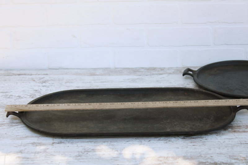 photo of vintage or antique cast iron griddles number 8-9, long oval pans gate mark bottoms #10