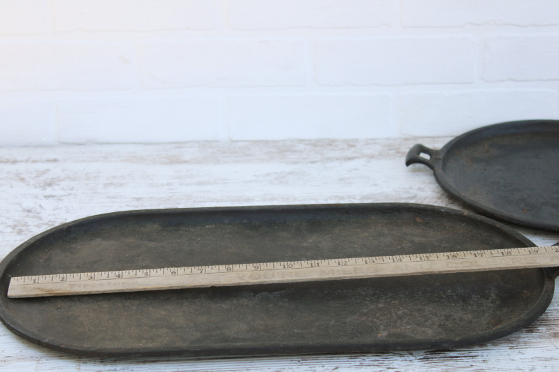 photo of vintage or antique cast iron griddles number 8-9, long oval pans gate mark bottoms #11