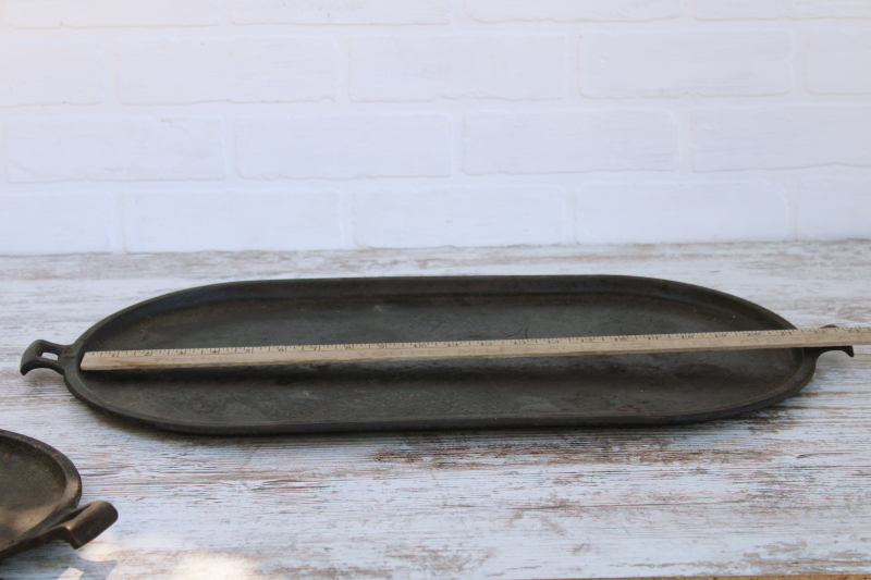 photo of vintage or antique cast iron griddles number 8-9, long oval pans gate mark bottoms #12