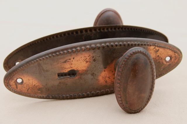 photo of vintage oval door knobs  beaded edge back plates,   antique tiger stripe japanned copper finish #1