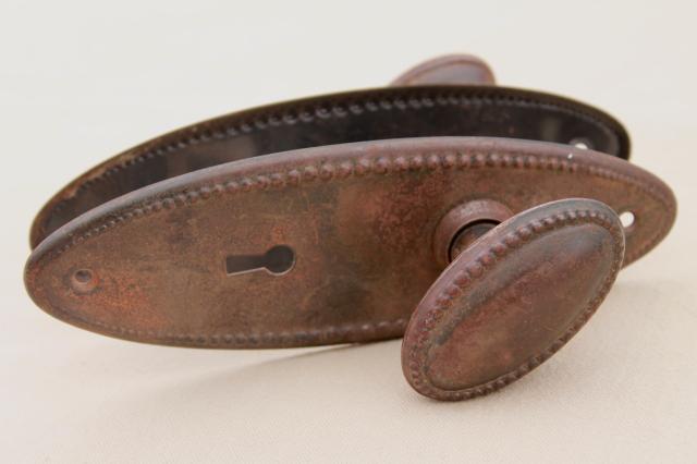 photo of vintage oval door knobs  beaded edge back plates,   antique tiger stripe japanned copper finish #4