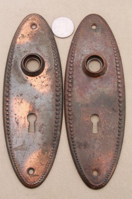 photo of vintage oval door knobs  beaded edge back plates,   antique tiger stripe japanned copper finish #5