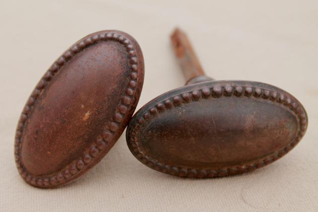 photo of vintage oval door knobs  beaded edge back plates,   antique tiger stripe japanned copper finish #8