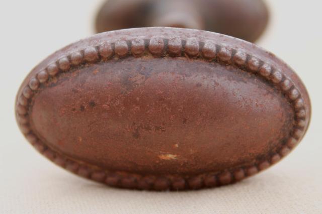 photo of vintage oval door knobs  beaded edge back plates,   antique tiger stripe japanned copper finish #10