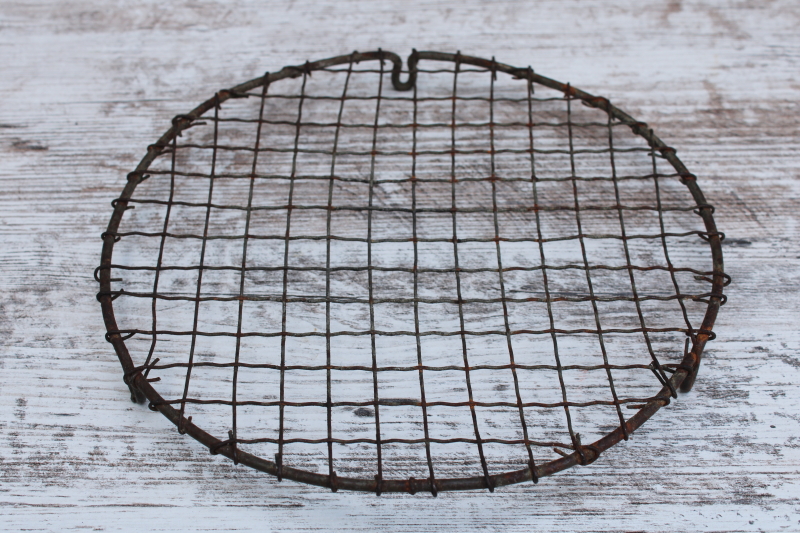 photo of vintage pie or cake cooling rack, little round stand wavy crimped wire w/ feet, baking photo prop #1
