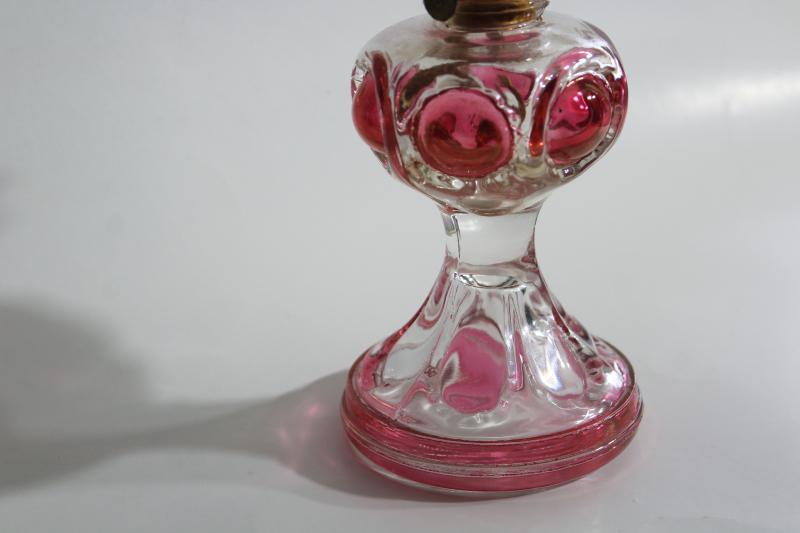 photo of vintage pressed glass oil lamp, bullseye pattern w/ ruby stain color #2