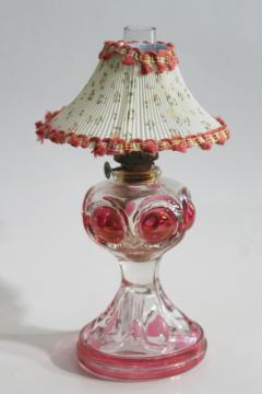 catalog photo of vintage pressed glass oil lamp, bullseye pattern w/ ruby stain color