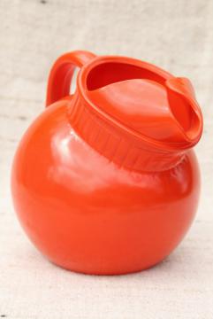 catalog photo of vintage round ball glass tilt pitcher, tomato orange red color kitchen glass jug for flower