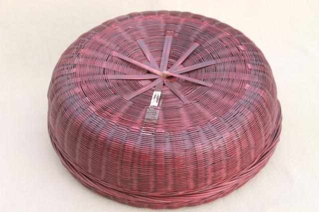 photo of vintage round wicker sewing basket full of spools of colored cotton thread #3