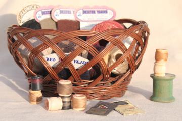 catalog photo of vintage sewing basket, paper cards of mending yarn, spools of darning cotton thread