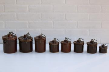 catalog photo of vintage stoneware crock jars, lot of 8 old brown cheese crocks w/ wire bails and lids different sizes