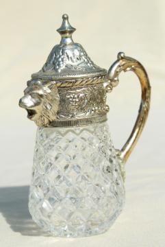 catalog photo of vintage syrup pitcher w/ ornate silver lion head, crystal clear glass jar