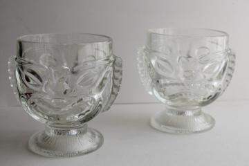 catalog photo of vintage tiki cups, large heavy clear glass heads for vases, candle holders, drinking glasses