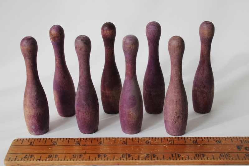 photo of vintage wood skittles pins or bowling toy pieces, worn weathered purple color #1