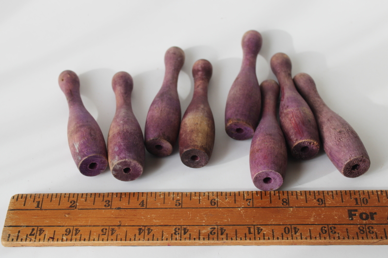photo of vintage wood skittles pins or bowling toy pieces, worn weathered purple color #3