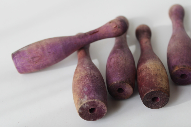 photo of vintage wood skittles pins or bowling toy pieces, worn weathered purple color #4
