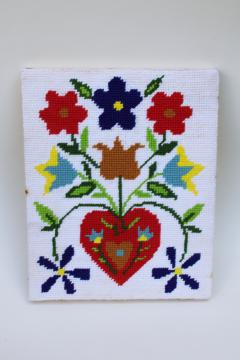 photo of vintage wool needlepoint picture, bright folk art heart flowers on wood stretcher frame