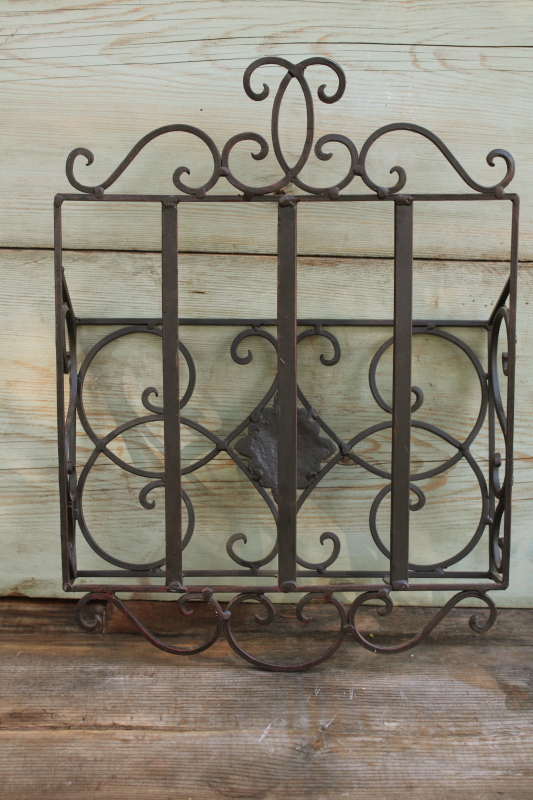 photo of vintage wrought iron magazine rack, heavy ornate black metal wall mount hanging storage #3