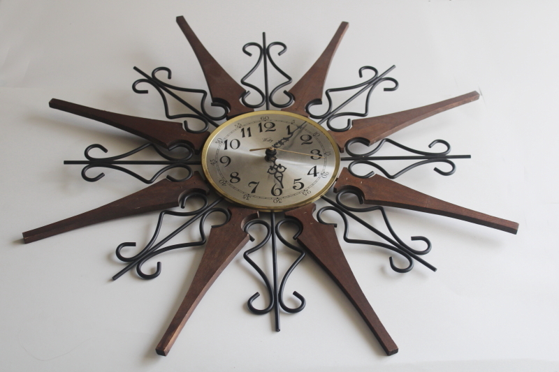 photo of working 70s vintage Welby sunburst wall clock, black iron with wood rays MCM  #1