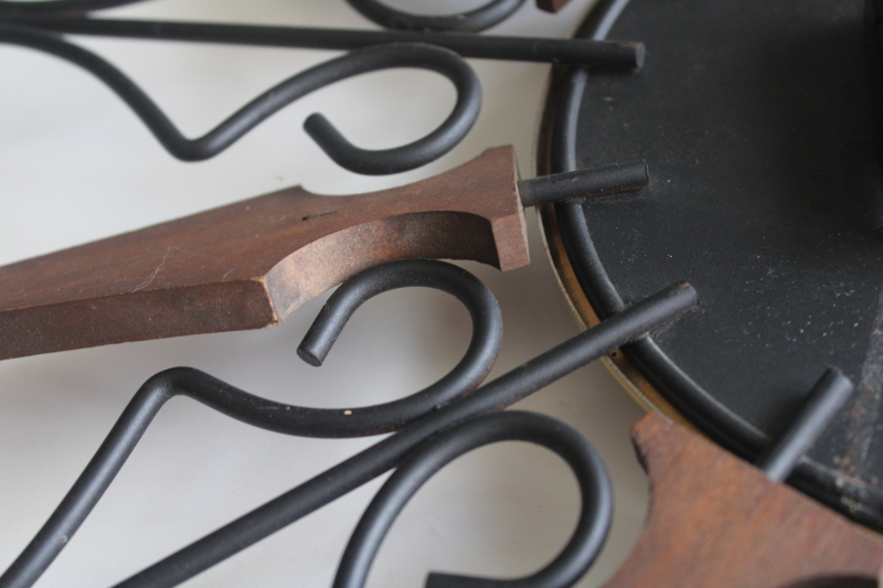 photo of working 70s vintage Welby sunburst wall clock, black iron with wood rays MCM  #2