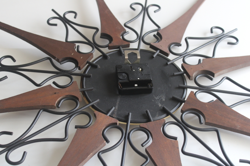 photo of working 70s vintage Welby sunburst wall clock, black iron with wood rays MCM  #8